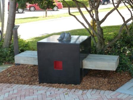 Abstract bench with shoes on top of bench